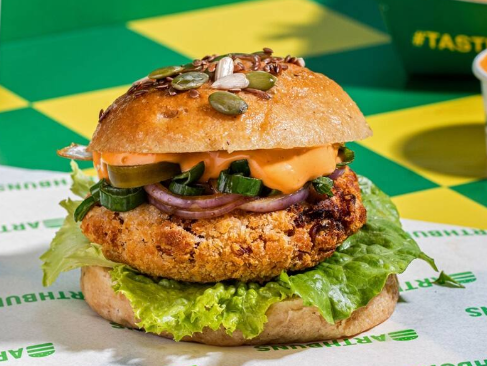 Earth Buns plant-based burger with fresh lettuce, onion and house sauce